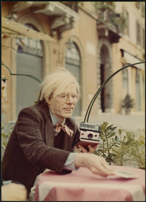 Andy Warhol with Polaroid camera, c. 1972