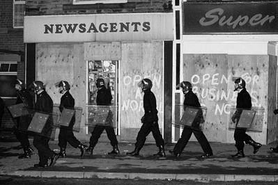 Police in riot gear patrol Grimethorpe during the miners str...