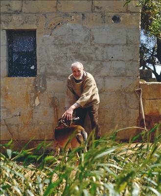 Victor Pasmore with his dog Zulu at the farmhouse in Malta, ...